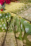 Green saree with white floral patterns on a table