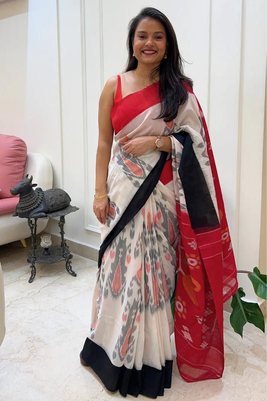 Woman wearing a handloom ikkat saree with a red blouse in an indoor setting