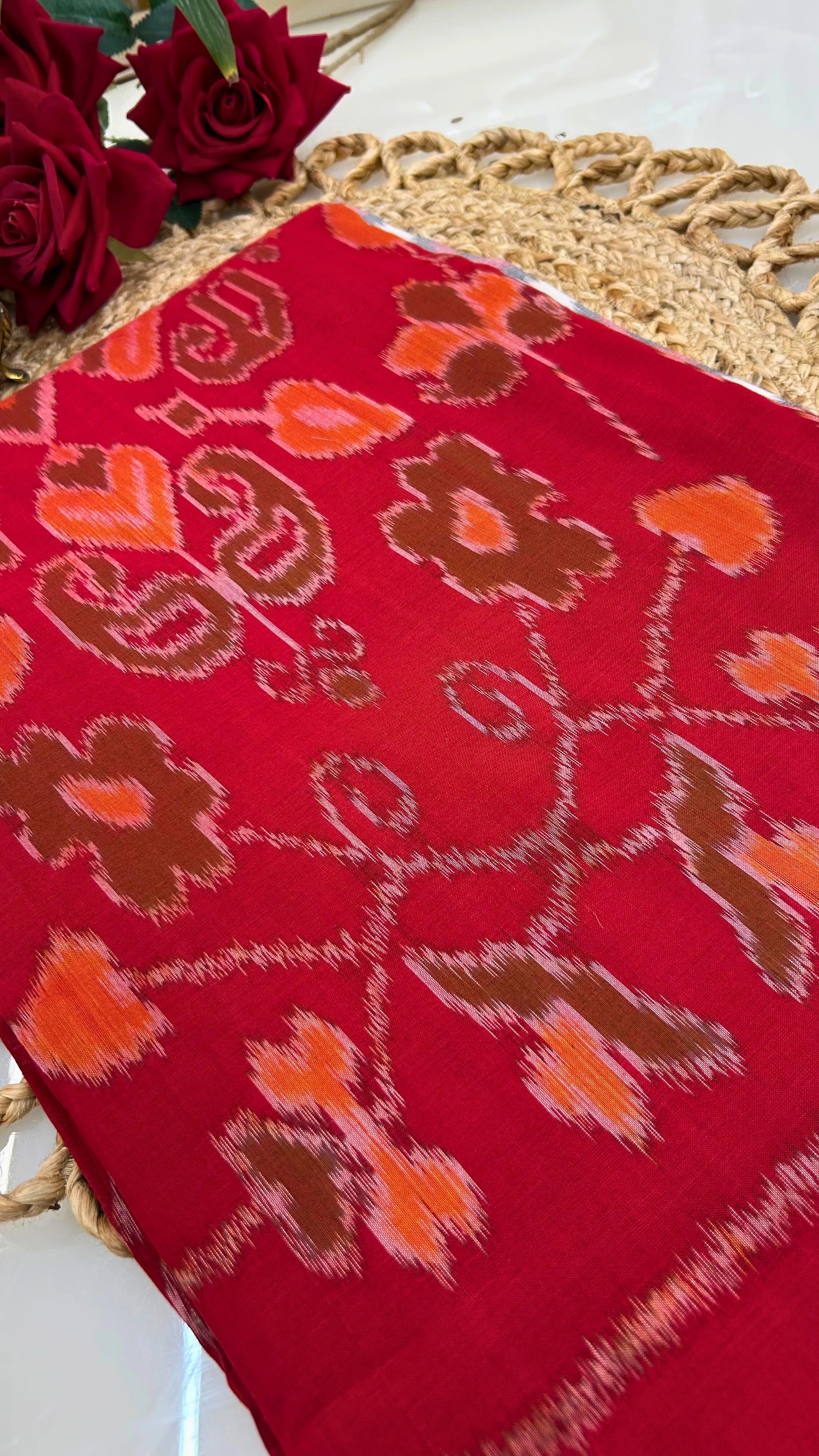 Close-up of red Ikkat cotton saree showing resist-dyed patterns