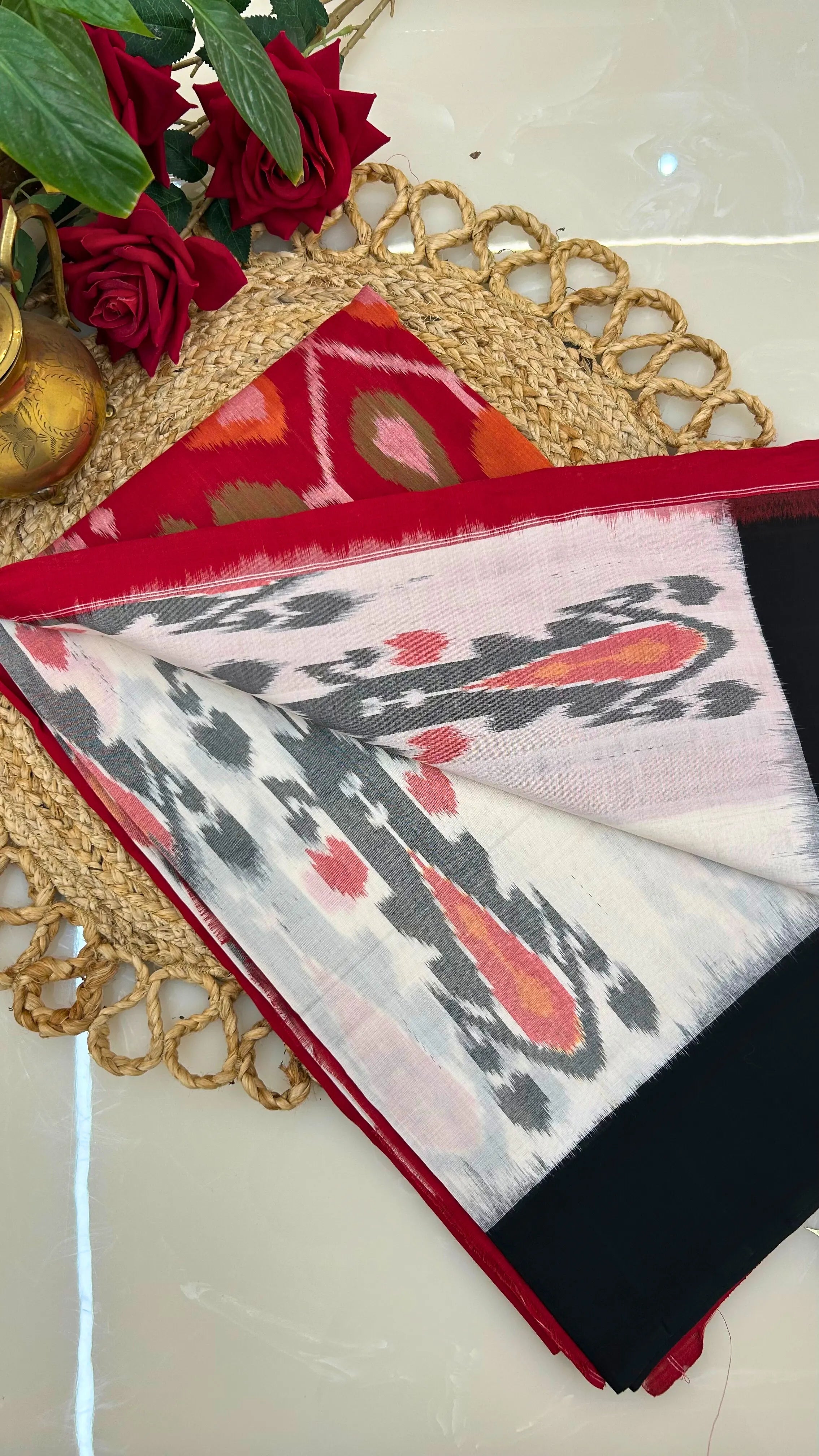 Ikkat cotton saree showing ivory and black contrast pallu