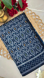 Folded deep blue Ikkat cotton saree with traditional handwoven design