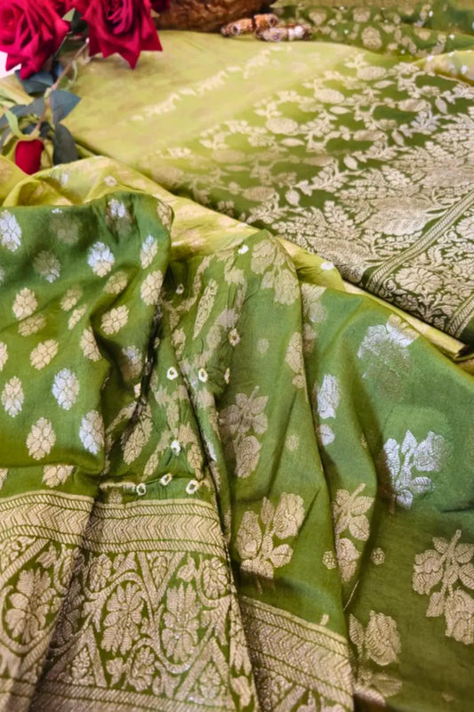 Green saree with white floral patterns on a table