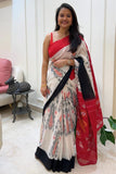 Woman wearing a handloom ikkat saree with a red blouse in an indoor setting