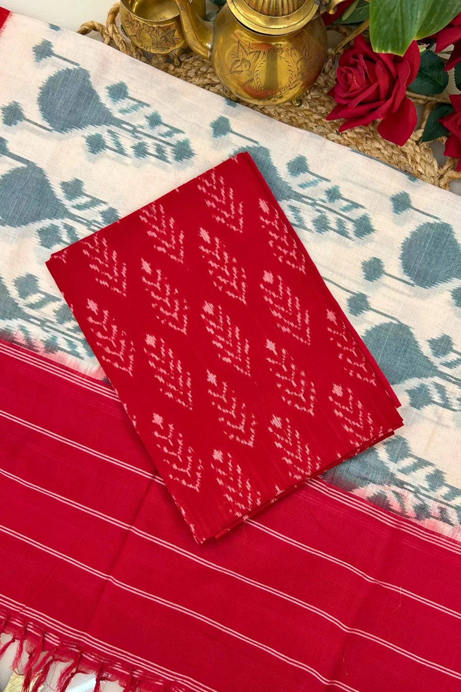 Red Ikakt cotton suit set with handwoven kurta fabric, matching dupatta featuring traditional resist-dyed Ikkat motifs.