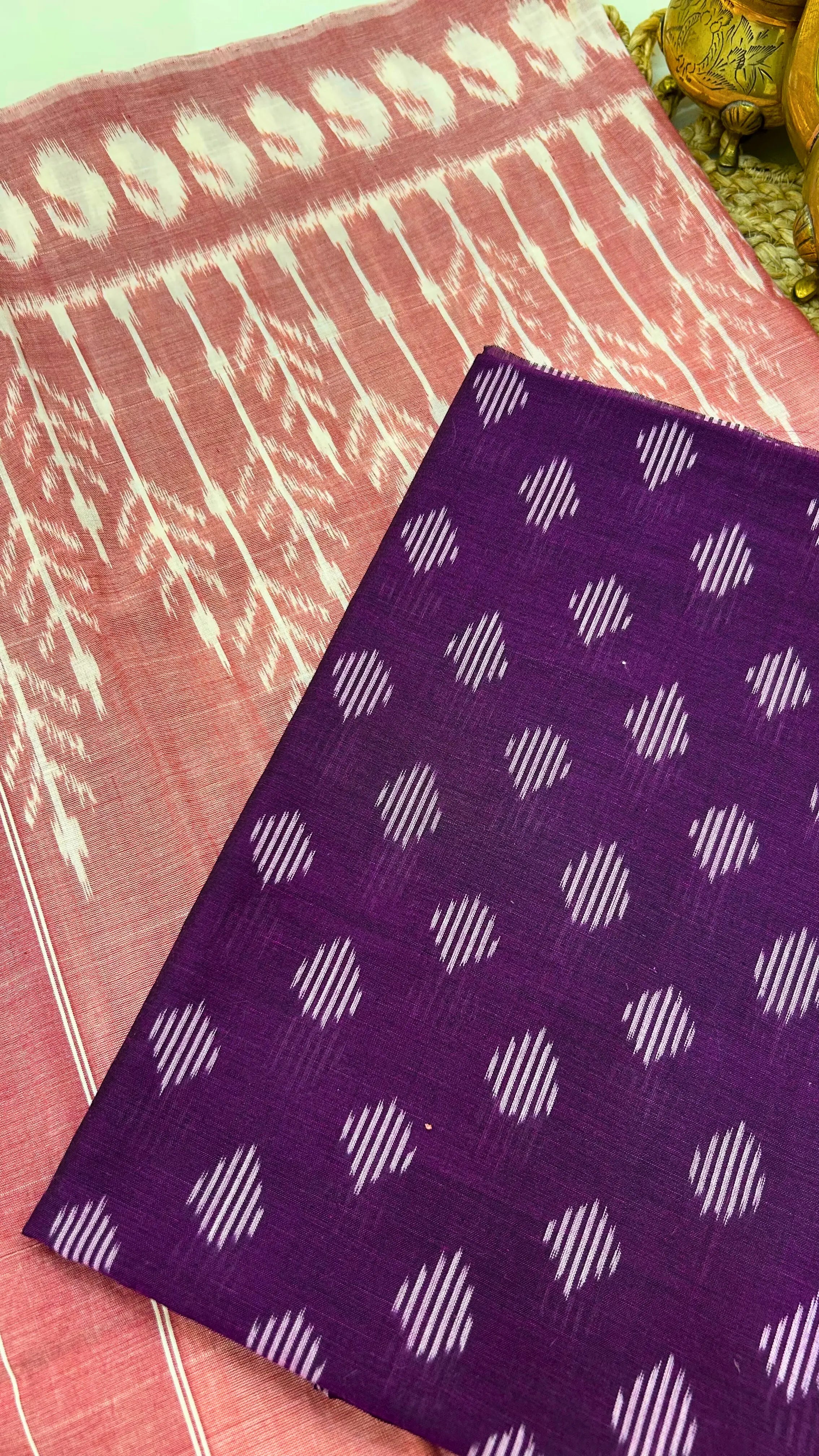 Close-up of purple Ikkat cotton fabric with traditional resist-dyed geometric motifs.