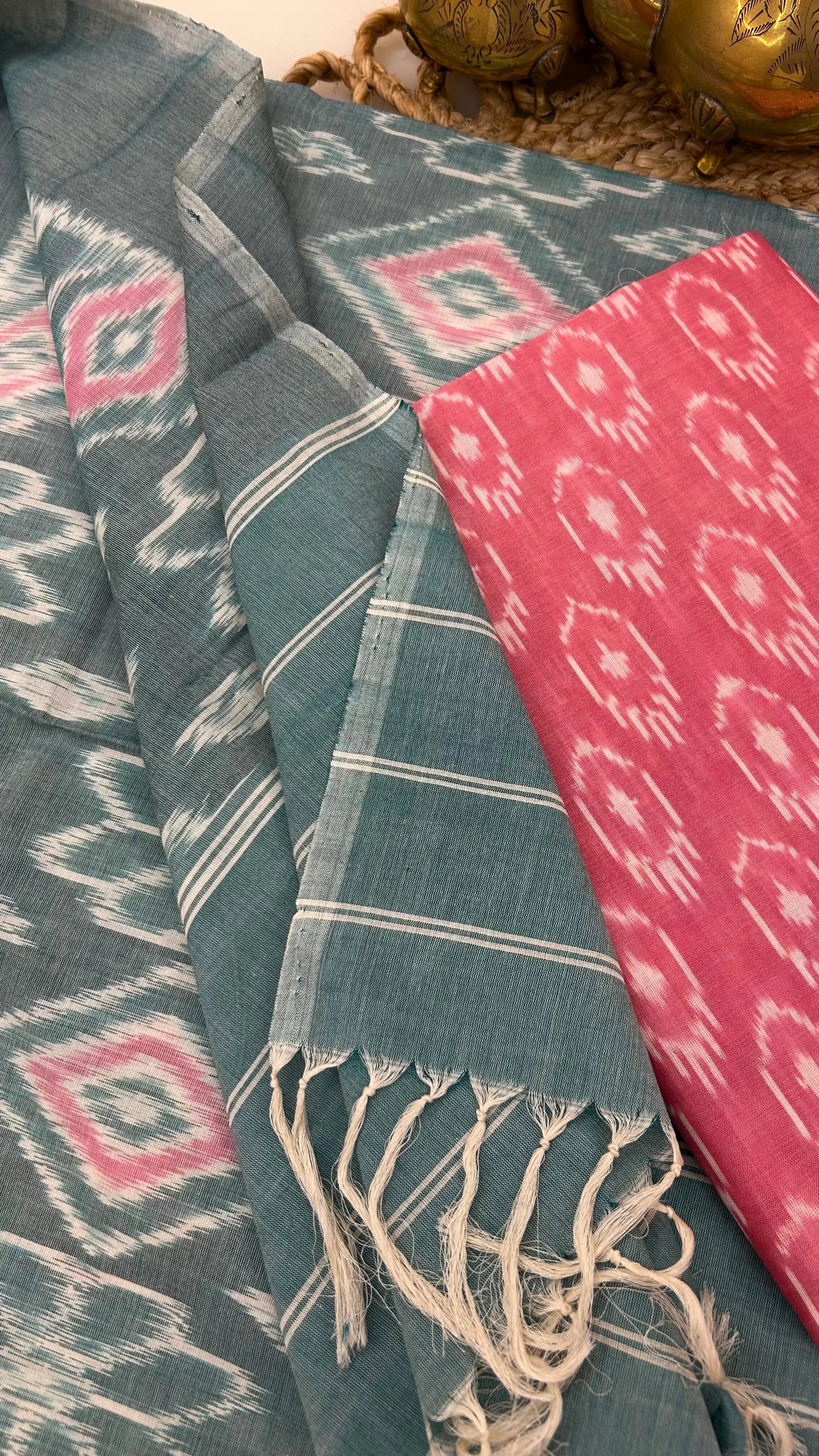 Handloom teal Ikkat cotton dupatta with striped borders and tassel detailing.