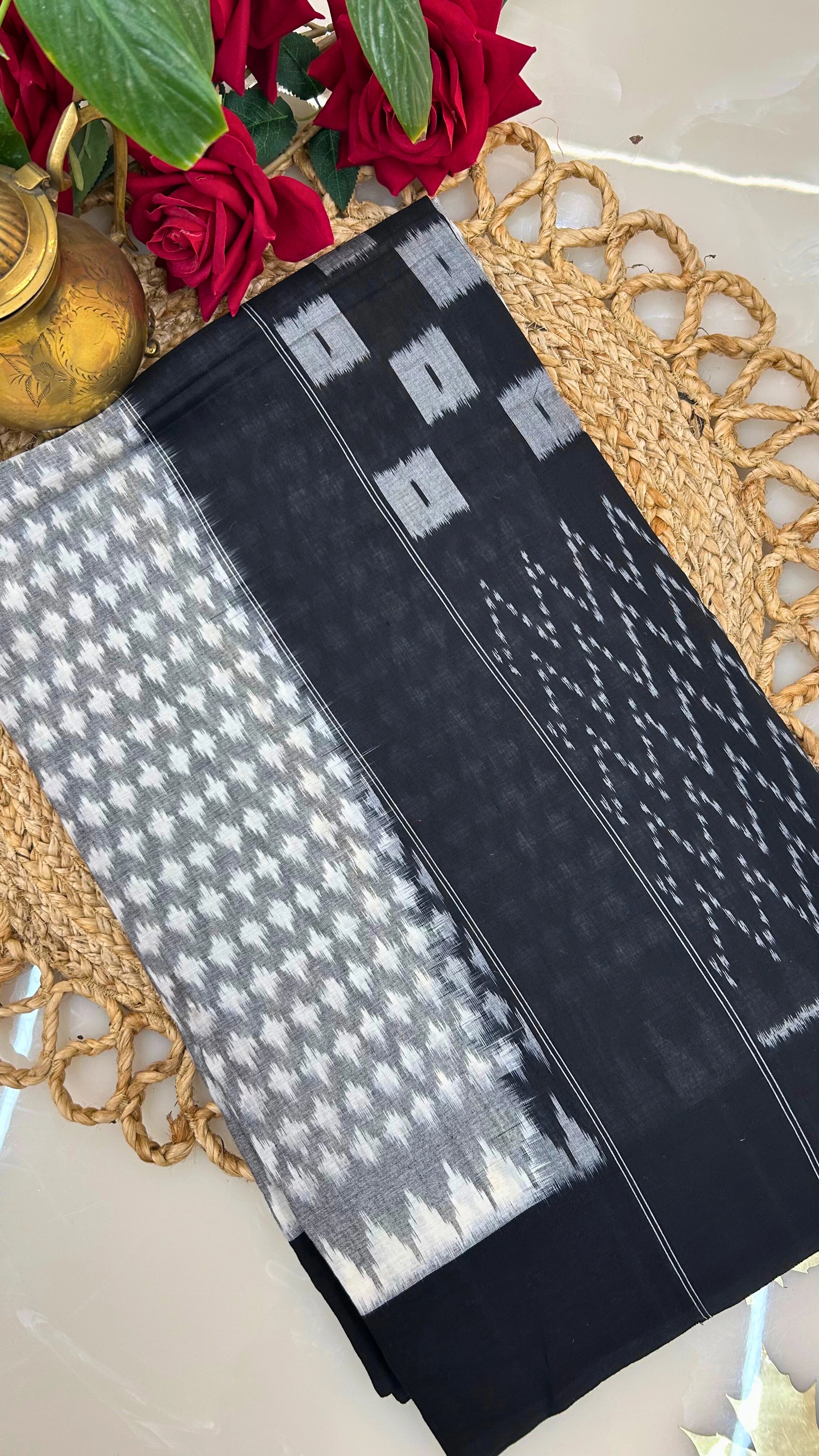 Black and grey handloom Ikkat cotton saree folded display