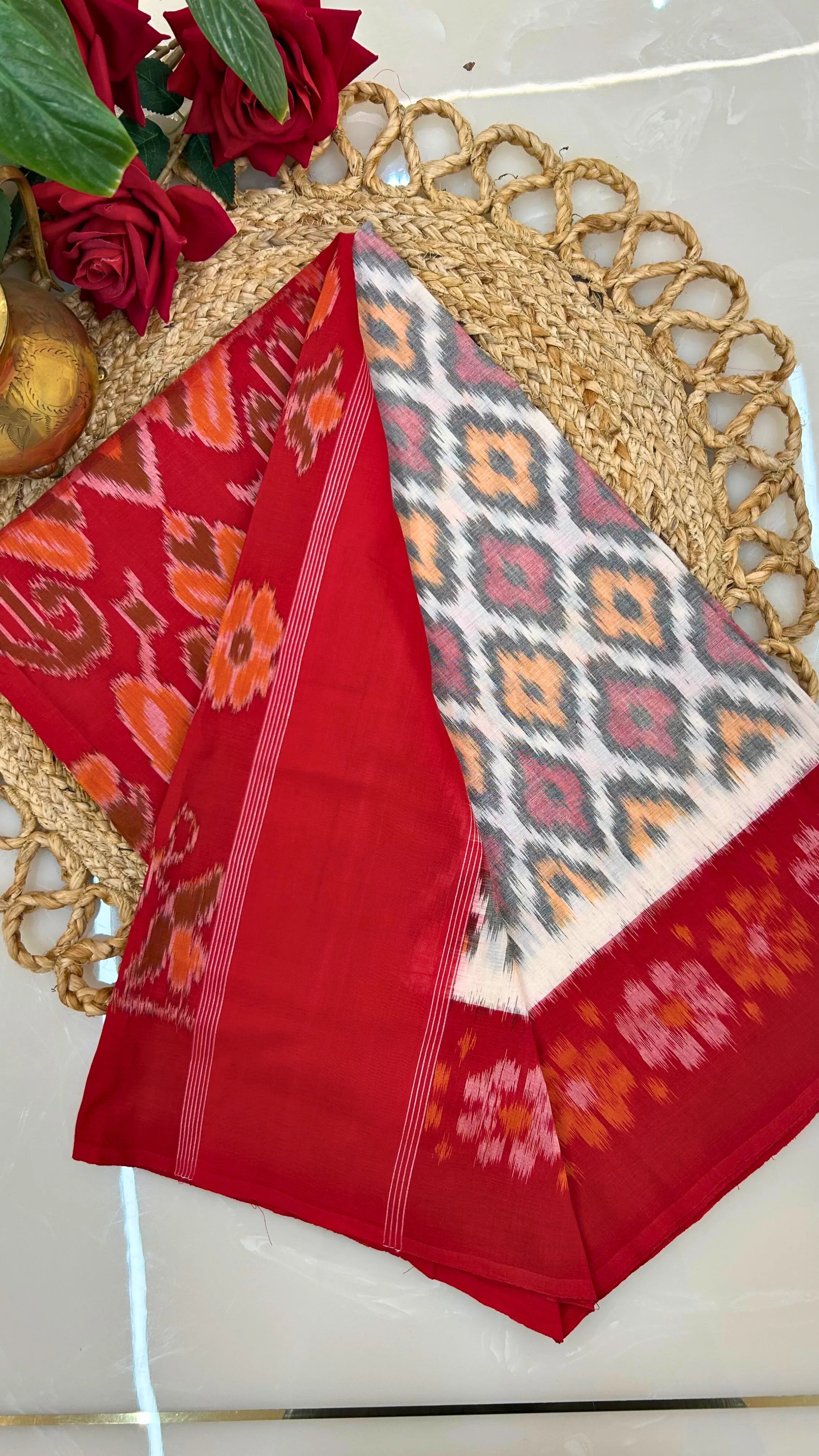 Red and white ikkat saree with floral patterns 