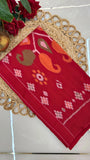 Folded red Ikkat cotton saree with traditional handwoven patterns